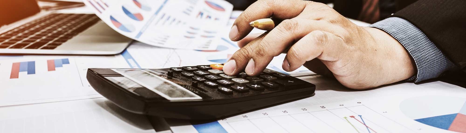 Close up of a financial worker using a calculator
