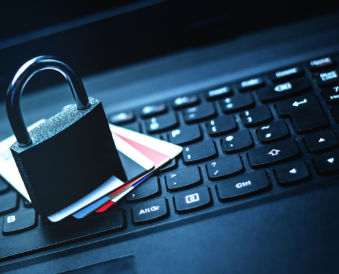 A Padlock and Cards On Top of a Laptop Keyboard