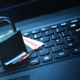 A Padlock and Cards On Top of a Laptop Keyboard
