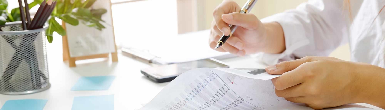 Close up audit woman calculate on paper document financial data_